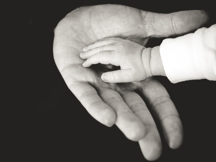 mała dłoń dziecka w dużej dłoni rodzica